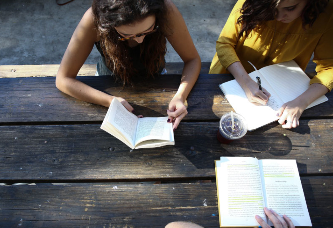 Group of people writing in notebooks